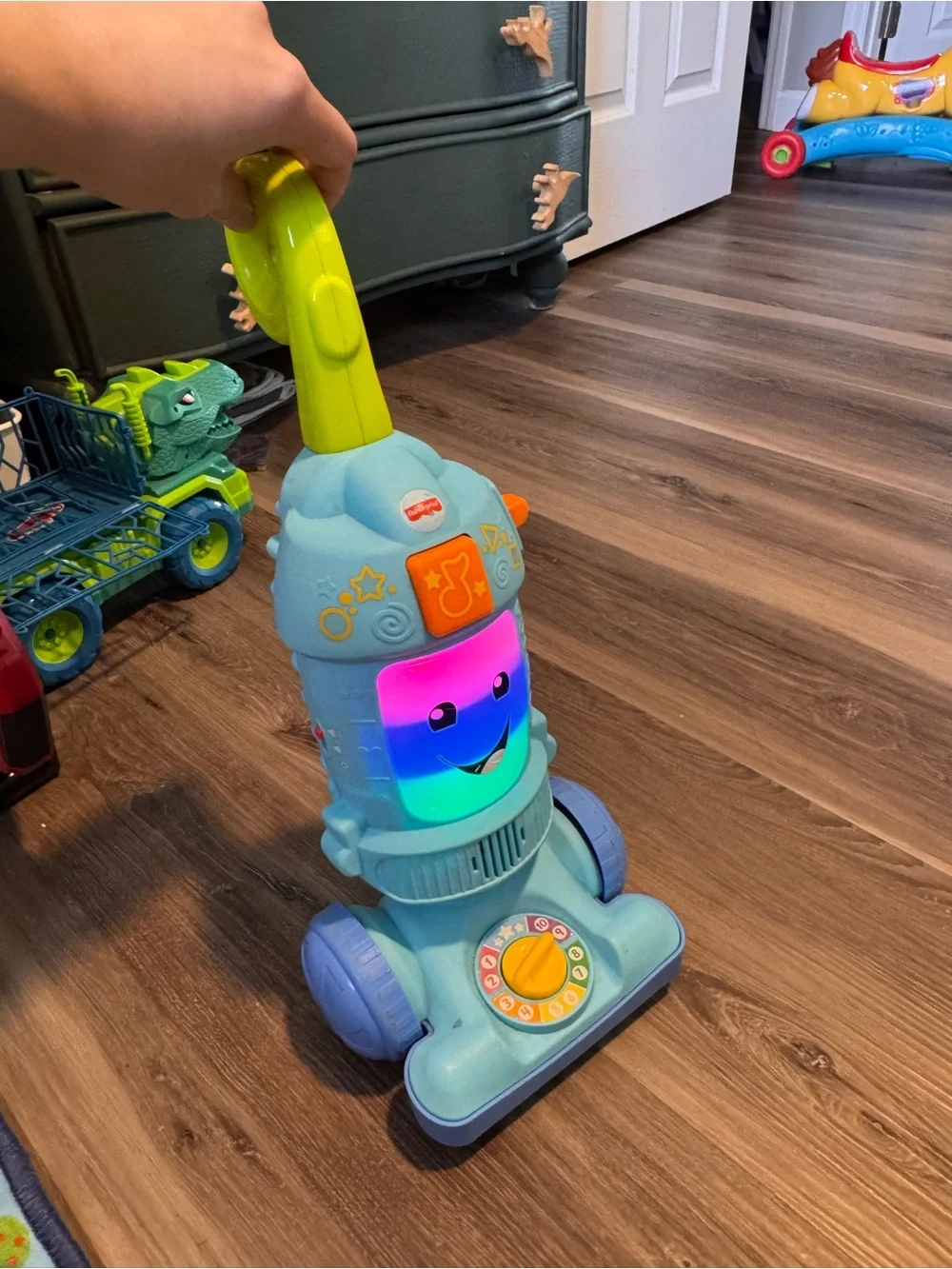 Fisher-Price Light Blue Toy Vacuum with Yellow-Green Handle and Purple Wheels